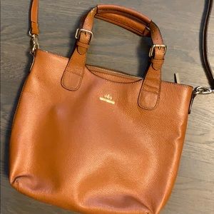 Witches cross shoulder woman’s bag.